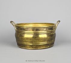 an antique brass bowl with handles