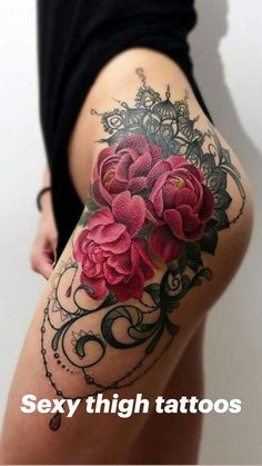 a woman's thigh with pink flowers on it and an ornate border around the thighs