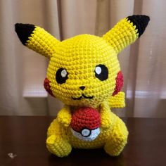 a crocheted pikachu sitting on top of a table