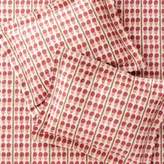 the red and white checkered fabric is folded on top of each other, with small circles