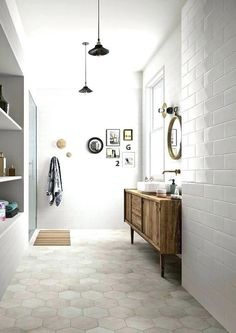 a bathroom with white walls and tiled floors