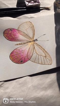 a drawing of a pink butterfly on white paper