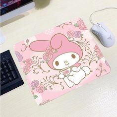 a mouse pad with an image of a bunny on it and a keyboard next to it