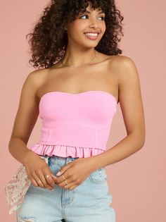 This feminine corset tube top with a peplum hem and a sweetheart neckline is the perfect top for a night out. The fitted silhouette is constructed from a snug yet stretchy material to ensure you have the perfect fit. Strapless Flirty Corset With Built-in Bra, Flirty Strapless Corset With Built-in Bra, Fitted Tube Top With Built-in Bra For Date Night, Fitted Flirty Tube Top With Built-in Bra, Feminine Strapless Tube Top With Ruffles, Feminine Strapless Ruffle Tube Top, Flirty Stretch Tube Top For Date Night, Feminine Fitted Tube Top With Built-in Bra, Fitted Elastane Tube Top For Night Out