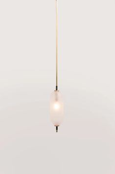 a white and gold colored light hanging from a ceiling