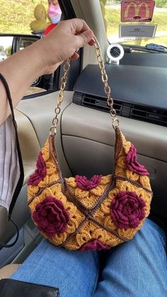 a handbag is being held in the back seat of a car