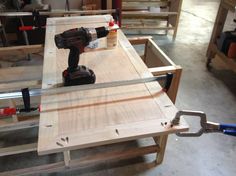 a cordless driller is being used to attach wood planks in a shop