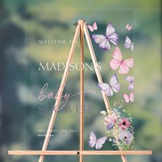 a wooden sign with flowers and butterflies on it that says, madison baby skyler