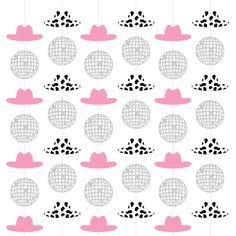 pink and black hats hanging from strings with polka dot dots on them, as if they were made out of paper