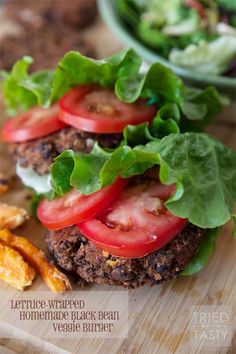 a hamburger with lettuce and tomatoes on it