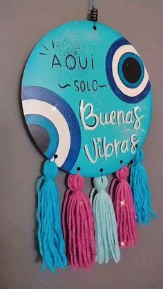 a blue sign with tassels hanging from it's side on a wall