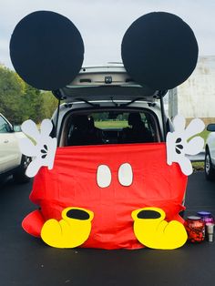 the back end of a car with mickey mouse ears on it's head and eyes