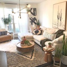 a living room filled with furniture and plants