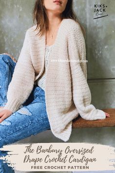 a woman sitting on top of a wooden bench wearing jeans and a cardigan sweater