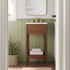 a bathroom with green walls and white towels on the shelf, along with a plant