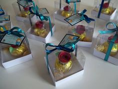 six clear boxes with roses and chocolates in them