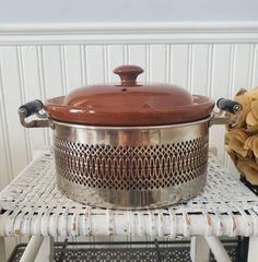 a large pot sitting on top of a white table