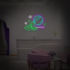 there is a neon sign on the wall next to a chair and table in this room