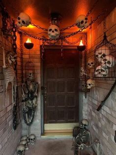 halloween decorations on the outside of a house with skeletons hanging from it's ceiling