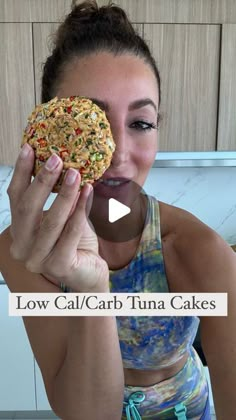 a woman holding up a cookie in front of her face with the caption low cal carb tuna cakes