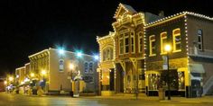 an empty city street at night with christmas lights