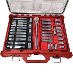 an open tool box filled with tools on top of a white surface and silverware in it