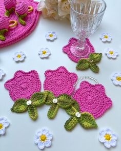 crocheted flowers are sitting on the table