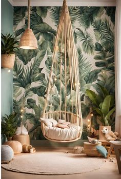 a baby's room with palm leaves on the wall and a hammock hanging from the ceiling