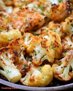 cooked cauliflower in a pan with parsley sprinkled on the top