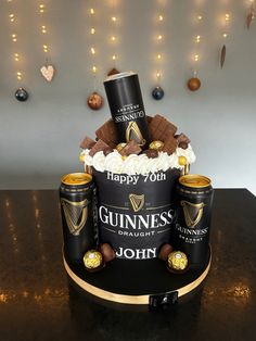 a birthday cake made to look like a guinness bottle with chocolates and marshmallows