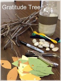 the crafting supplies are laid out on the table to make a tree branch decoration