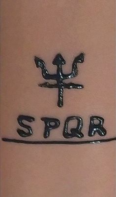 the word spqr written in black ink on a woman's stomach is shown