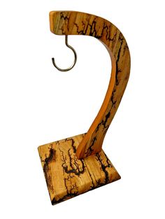 a wooden sculpture with an umbrella hook on it