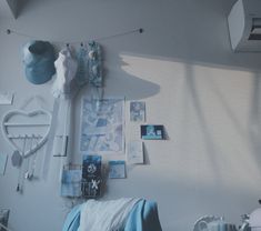 a bedroom with white walls and blue decor on the wall above it is a bed