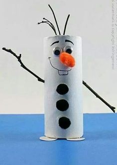 a toilet paper roll with a frozen snowman face on it and some twigs sticking out of it