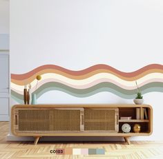 a living room with a wall painted in pastel colors and a wooden entertainment unit