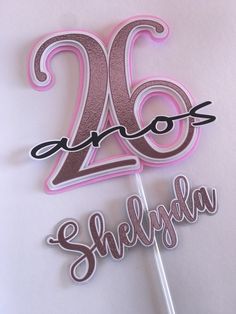 a pink and silver cake topper with the number twenty two