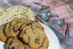 three chocolate chip cookies on a white plate