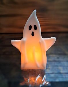 a lit up ghost sitting on top of a table