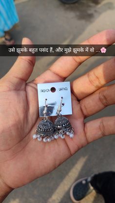 someone is holding some kind of earring in their hand with the caption on it