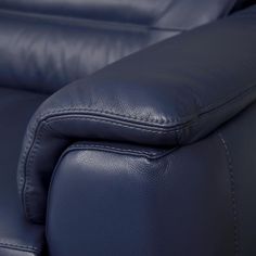 the back end of a blue leather reclining chair with stitching on it's arm