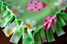 a ladybug and flower print blanket on a table