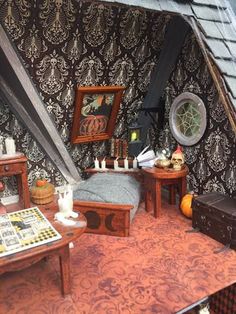 a doll house with furniture and decorations on the floor in front of a wallpapered background