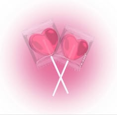 two heart shaped lollipops sitting on top of each other