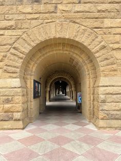 an arched stone building with a checkered floor