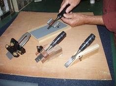 a man is working on some woodworking tools