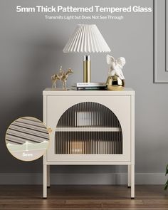 a white lamp sitting on top of a table next to a book shelf