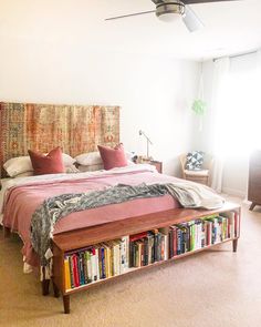 an instagram photo of a bed with bookshelves on the headboard and pillows