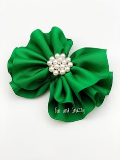 "This listing features a beautiful ruffled emerald, green hairbow that is made from grosgrain ribbon and is topped with a super cute pearl notion. The green hair bow comes on a lined alligator clip. Beautiful hair bow to match with a special St. Patrick's Day outfit! Bow size: 5''  Check out our \"Bow\" collection: https://www.etsy.com/shop/FunNSnazzy?ref=seller-platform-mcnav&section_id=35359780 IMPORTANT NOTE Headbands may contain small parts. Children should always be supervised while wearing this or any other headband. Once the product is in your hands you are responsible for proper use. We take pride in our unique designs, and our quality. We take time to do things right & use high quality materials. We believe that our customers deserve to be buying the very best that we have to offe St Patricks Day Clipart, Custom Bunny, Kids Hair Bows, St Patrick's Day Outfit, St Patrick's Day Decorations, Beautiful Hair Accessories, Green Bows, Ribbon Hair Bows, Large Bow