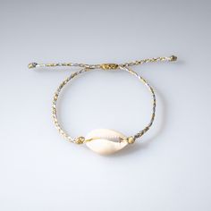 Braided Cowrie Shell Bracelet with a single shell attached to a duo color wax-coated cord. Each item is handmade and unique, may have slight variations. Adjustable Bracelet: 5.75" - 9" Please allow 3-5 days for items to ship Handmade in Greece OIYA Cowrie Shell Bracelet, Embroidery Bracelet, Cowrie Shell Necklace, Embroidery Bracelets, Shell Bracelet, Cowrie Shell, Sustainable Brand, Bracelet Collection, Shell Necklaces